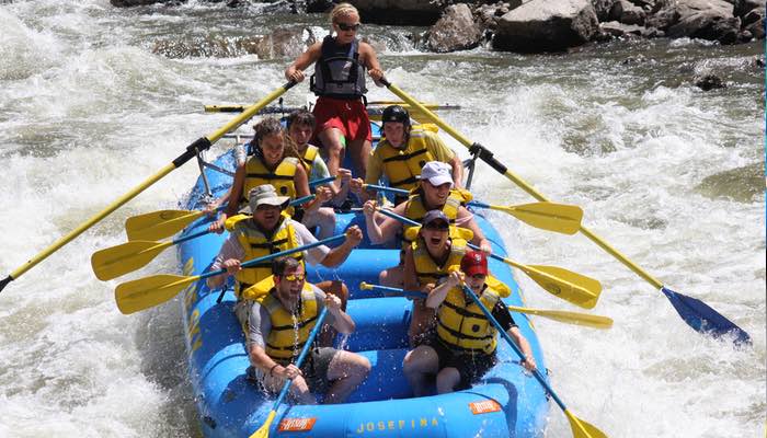 Blue Sky Rafting Photos This image features a family joyfully navigating the Shoshone Rapids with their raft guide.