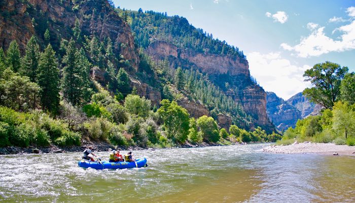 This serene photo captures a boat gracefully floating on the calm Class II waters of the river.